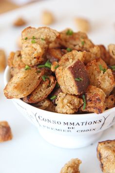 a white bowl filled with fried food on top of a table