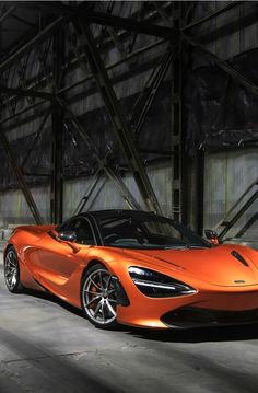 an orange sports car parked in a garage