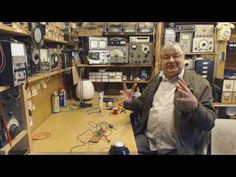 a man standing in front of a table filled with electronics