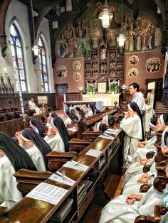 several people sitting at desks in a church