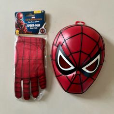 a spider - man mask and glove are sitting on the table next to each other