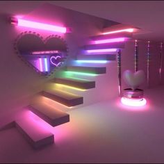 there is a heart shaped mirror on the wall next to some stairs that are lit up with neon lights