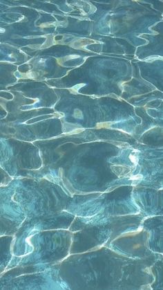 the water is crystal blue and has ripples on it's surface, as seen from above