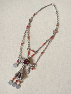 This is a beautiful old silver berber necklace from morocco with old coral beads, old silver coins, enamel pendant and silver cônes. Measure of the pendant : 11,5 cm x 7 cm (4,5 inches x 1,77 inches) Length : 53,8 cm (21,1 inches) Weight : 61,5 g Amazigh Jewelry, Berber Necklace, Algerian Jewelry, Old Silver Coins, Berber Jewelry, Moroccan Jewelry, Coral Beads, Red Bead, Silver Pendants