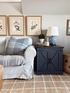 a living room filled with furniture and pictures on the wall