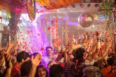 many people are throwing confetti and streamers in the air at a party