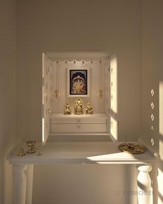 a white shelf with some gold decorations on it