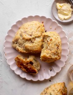 three muffins on a plate with butter