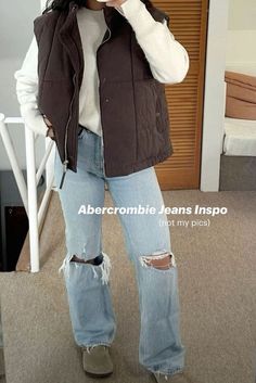 casual fall outfit: puffer vest and jeans White Long Sleeve With Vest Outfit, Cute Outfits With Vests Fall, Snow Vest Outfit, Army Green Puffer Vest Outfit, Boston Day Trip Outfit, Vest Outfits Puffer, Rust Vest Outfit Fall, Chocolate Brown Puffer Vest Outfit, Fall Canada Outfits