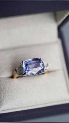 a blue ring sitting on top of a white box