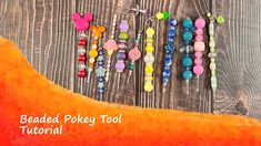 the beaded pokey tool is laying on top of an orange cloth with beads