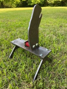 a metal object sitting on top of a green field