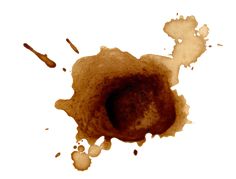 coffee stain on white paper with brown spots in the center and one spot at the bottom