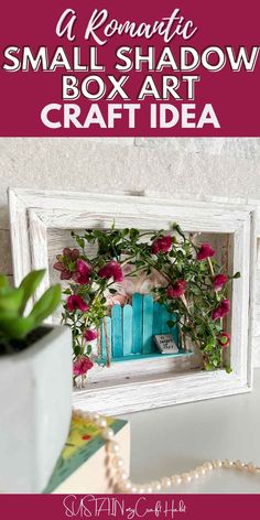 a small shadow box art craft idea with pink flowers and greenery in the window