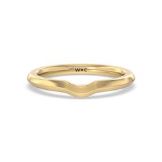 a yellow gold wedding band with the word w c on it's side, in front of a white background