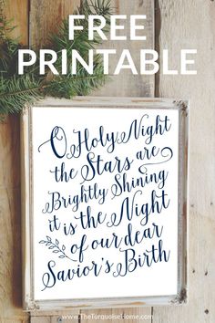 the free printable christmas sign is displayed on a wooden table with pine branches and evergreens