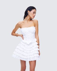 Bring your ruffle flair to the next level in this playful white mini dress 🤍 With 7 tiers of ruffles, a V-waist seam, and a fit and flare silhouette - this piece, made from plain-weave fabric, is your ticket to getting everyone to swoon over you 😌 Weave Fabric, Graphic Top, Ruffle Mini Dress, White Jersey, Ruffle Shorts, Mini Wrap Dress, Black Ruffle, Plain Weave, White Mini Dress