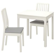 a white table with two chairs next to it and a gray cushion on the seat