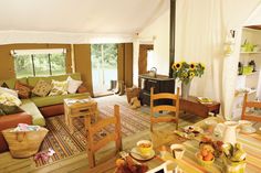 a living room filled with furniture and a fire place next to a table covered in flowers