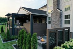 an outdoor patio with fire pit and landscaping