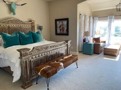 a large bed sitting in a bedroom on top of a carpeted floor next to a window