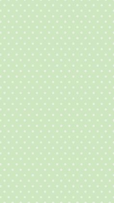 a green background with white polka dots