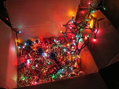 a pile of christmas lights sitting on top of a floor