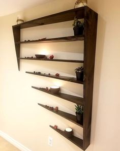 the shelves are made out of wood and have candles on them