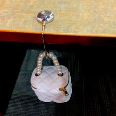 a white purse sitting on top of a table