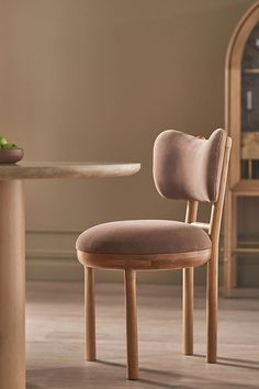 a wooden chair sitting in front of a table