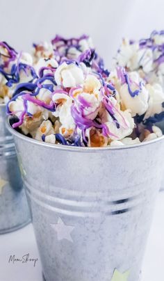 a bucket filled with purple and white popcorn