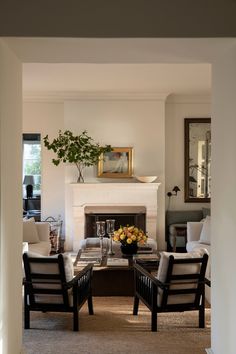 a living room filled with furniture and a fire place in the middle of a room