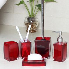 the bathroom accessories are red and clear