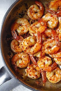 cooked shrimp in a skillet with a fork