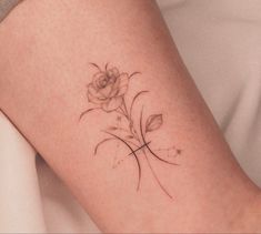 a tattoo on the leg of a woman with a cross and flower in it's center