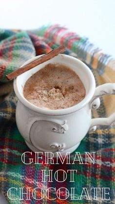 there is a cup of hot chocolate with cinnamon on the top and in the middle