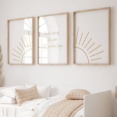 two framed art prints above a bed in a white bedroom with beige pillows and blankets