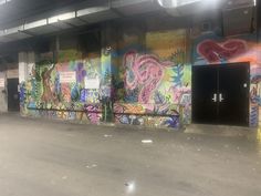 an empty parking garage with graffiti on the walls