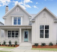 a white house with blue doors and windows on the front porch is pictured in this rendering