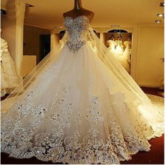 a wedding dress is on display in a room with mannequins and lights