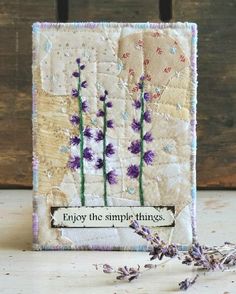 an embroidered card with lavender flowers and the words enjoy the simple things written on it