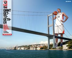 a man holding a basketball standing on top of a bridge