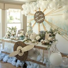 a table with balloons and decorations on it