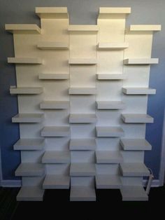 a large stack of white shelves in a room