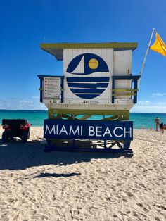 a lifeguard tower on the beach with people walking around