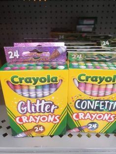 two boxes of crayons are sitting on a shelf in a store, one is yellow and the other is pink