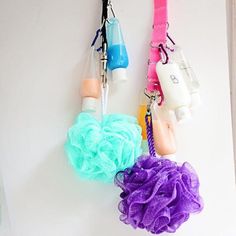 two hair products hanging from hooks on a wall with other items attached to it's sides