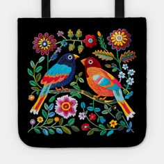 two colorful birds sitting on top of a black tote bag with flowers and leaves