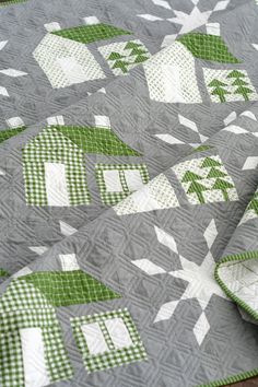 a quilt with green and white designs on it