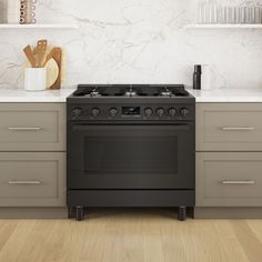 a black stove top oven sitting inside of a kitchen